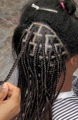 Client with long, neatly parted box braids